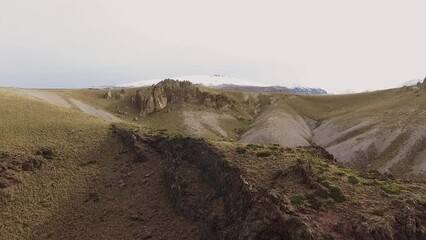 Sticker - Aerial view of the Andes mountains, yellow grass, sand dunes, and rocky cliffs in Volcano Domuyo, Neuquen, Patagonia Argentina. 