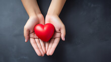 Top View Photo Of Hands Holding Red Heart On Black Background, Healthcare, Love, Organ Donation, Mindfulness, Wellbeing, Family Insurance And CSR Concept, World Heart Day.