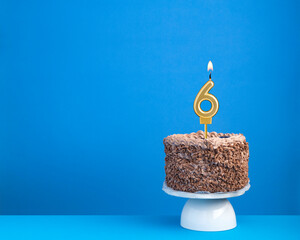 Birthday celebration with candle 6 - Chocolate cake on blue background