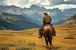 A horse wrangler riding solo on horse in mountains