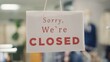 © DC Studio - Extreme close up shot of message on designer clothing men premium showroom door announcing customers that shop is closed. Sorry we are closed sign in luxury fashion boutique with elegant clothes