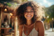 Generative AI Image Of Cheerful Young Woman With Curly Hair Smiles Brightly Looking At Camera Against A Blurred Tropical Background