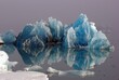 © imageBROKER - Blue iceberg reflected in the water, mountains rising out of the mist, Joekulsarlon, glacier lagoon, Scandinavia, Iceland, Europe