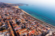 Aerial photo of Premia de Mar with view of residential buildings along Mediterranean Sea coast, Catalonia, Spain.