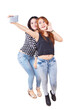 © Creativa Images - Group of happy teenage girls having fun and taking self picture together in the studio