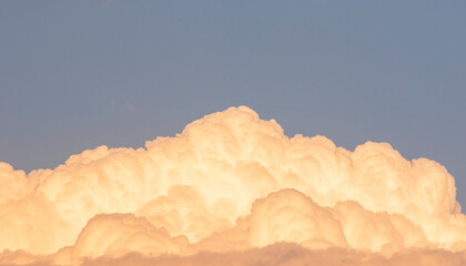 Wall Mural - Cloudscape, Colored Clouds at Sunset near the Ocean on a Blue Sky