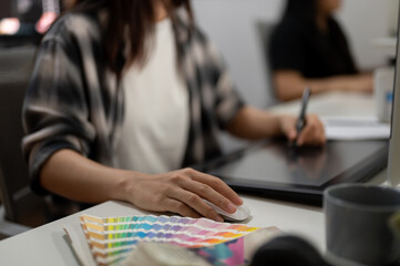 Poster - close-up image of a professional female graphic designer illustrator artist working in the office.