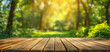 Wood floor with blurred trees of nature park background and summer season, product display montage.