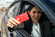 Young Beautiful Asian Business Women Getting New Car. Hand Holding Credit Card Payment. Car Owner Paying Fuel Pump With Credit Card Customer Mileage Point Loyalty Reward. Driving Vehicle On The Road