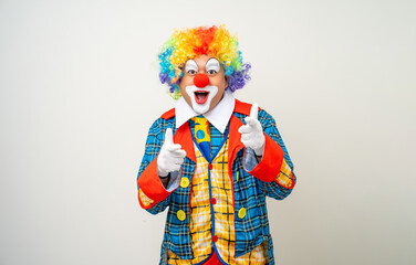 Wall Mural - Mr Clown. Portrait of Funny comedian face Clown man in colorful uniform wearing wig standing pointing finger to camera. Happy expression amazed face male bozo in various pose on isolated background.