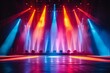 © ParinApril - Concert stage lit with colorful spotlights and beams against a dark backdrop.