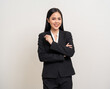 © Chanakon - Attractive Young asian business woman smiling to camera standing pose on isolated white background. Latin Female around 25 in black suit portrait shot in studio.
