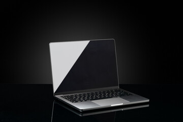 Canvas Print - Open laptop with black screen against black background