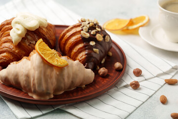 Wall Mural - Glazed croissants on clay plate on table