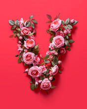 Floral Letter "V" Made Of Pink Rose Flowers, Red Color Background, Valentines Day Concept