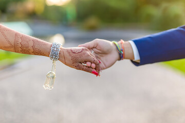 Indian couple's holding hands close up