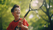 asian boy play badminton in park