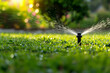 watering the lawn grass in the park water splashes against the backdrop of the sun Generative AI