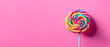 a sweet and delicious lollipop isolated on pink background with copy space