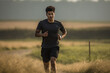 indian professional runner jogging across a field, in the style of stylish, black and gray, sigma 105mm f/1.4 dg hsm art, utilizes, composed, installation-based, subtle


