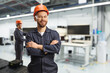 © Ljupco Smokovski - Technician in a uniform with a helmet and goggles in a factory