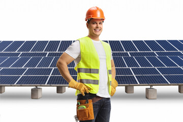 Wall Mural - Construction worker with a helmet and tool belt on a solar farm