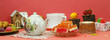 Panorama in the form of a table with a cup of tea and desserts. Marmalade, cookies, tea, teapot and decorative items on a pink background.