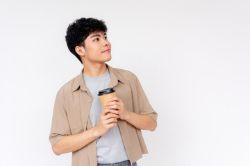 Wall Mural - A thoughtful young Asian man holding a coffee cup, looking upward with a contemplative expression, isolated on white.