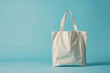 Wall Mural - White tote bag without words isolated on light blue background. Mock up