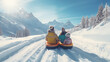 Family tubing down a snowy hill with mountain backdrop,rear view