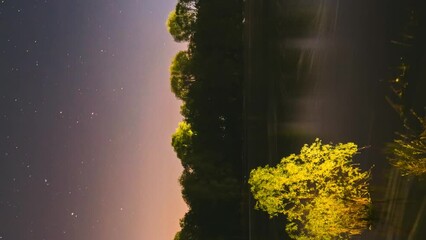 Wall Mural - Meditation By The Water. 4k Hyperlapse Meteors Fly Across The Night Sky. Night Sky Above River. From Dusk To Dawn. Stars Float Across Sky. Night Sky Turns Into Morning. Dawn Is Coming. Calmness And