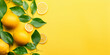 Fresh ripe lemons limes and green leaves on yellow background flat lay Flat lay composition with lemons .