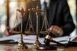 shot of a gavel and justice scale in the foreground with a lawyer consulting legal documents in the background, in a courtroom. Created Using: artistic photography, symbolic legal objects, lawyer in b