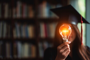 Wall Mural - Education, e-learning graduate certificate and business concept, Women showing light bulb with graduation hat in hand Education technology study knowledge, human creative thinking idea