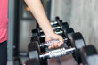 © Chalearmrat - Rows of stainless dumbbell in the gym, Sports dumbbells in modern sports club.