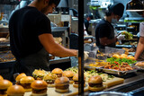 Fototapeta  - A cozinha de uma hambúrgueria com os cozinheiros preparando os lanches  