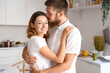 © Pixel-Shot - Happy couple in love hugging in kitchen