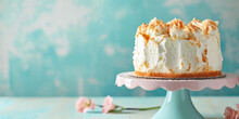 Angel Food Cake On Pastel Blue Background With Copy Space.  Elegant Fluffy Sponge Angel Food Cake On A Cake, Perfect For High Tea Or Dessert.