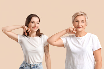 Poster - Beautiful women doing face building exercise on beige background