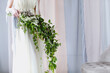 Bride in delicate gown with unusial bouquet of small white flowers