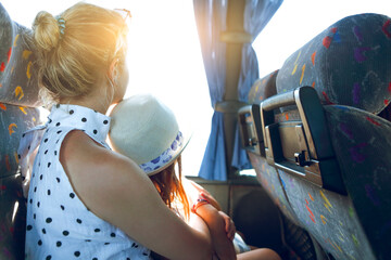 Woman with little daughter sitting in bus