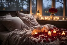 Soft bed covered with red rose petals. Romantic bedroom setting for anniversary or Valentine's Day.