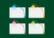 © yasin - blue, orange, pink and green table lamp symbol and note paper. note papers and colorful table lamps on green background
