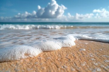 Poster - A close up view of a wave crashing onto a sandy beach. Perfect for beach and nature-themed designs