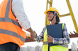 © Supachai - Asian female civil engineers wearing vest and helmet safety handshake to work successfully at factory making precast concrete wall in construction site.