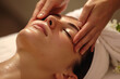 woman receiving a facial massage in spa for relaxation
