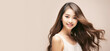 © FoxTok - Portrait of beautiful Asian girl on light background. Young attractive Japanese woman with long hair smiles and looks at the camera. Cosmetology, beauty, fashion