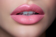 Close up view of beautiful woman lips with pink lipstick. Cosmetology, drugstore or fashion makeup concept.
