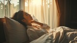 Fototapeta  - Simple lifestyle, Asian woman wakes up from good sleep on weekend morning, takes some rest, relax in comfortable bedroom at hotel window, happy lazy day, comfortable, dreaming