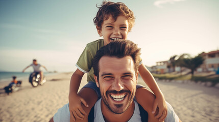 Caucasian boy riding on the back of his father at the beach.